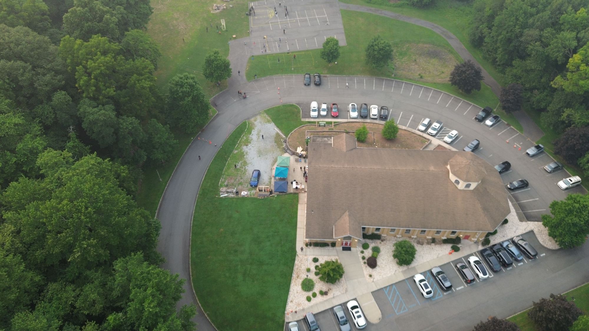 Aerial view of the church building and grounds in Blauvelt, surrounded by trees