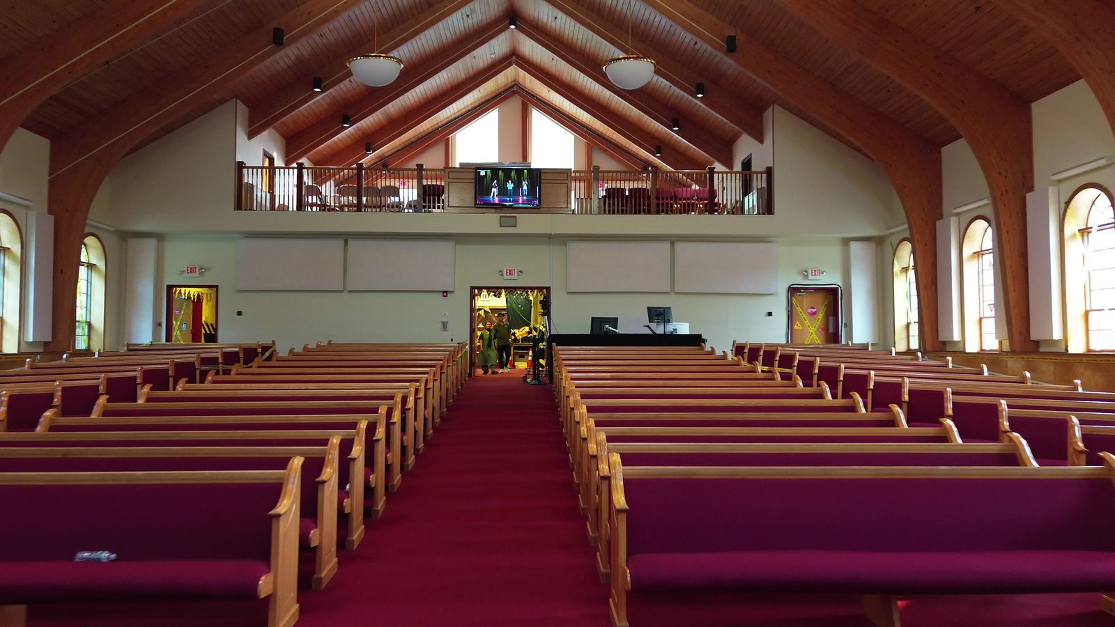 The sanctuary viewed from the front, with rows of pews and the balcony